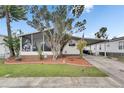 Charming home featuring a screened porch, well-manicured lawn, and covered parking at 9417 Star Gazer Ln, Riverview, FL 33578