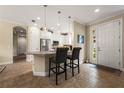 Bright kitchen featuring white cabinets, stainless steel appliances, and pendant lighting over the breakfast bar at 11309 Callisia Dr, Odessa, FL 33556
