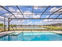 Beautiful pool and lake view from the backyard at 1201 Blue Shell Loop, Sarasota, FL 34240