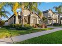 One-story house with screened porch, lush landscaping, and palm trees at 13634 Ashlar Slate Pl, Riverview, FL 33579