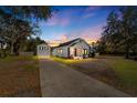 House exterior at sunset, showcasing a red door and detached garage at 1402 N Gordon St, Plant City, FL 33563