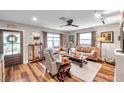 Cozy living room featuring a ceiling fan, luxury vinyl floors and comfortable seating at 147 Se Lincoln N Cir, St Petersburg, FL 33703