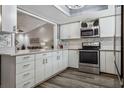 Bright kitchen featuring white cabinetry, stainless steel appliances, and modern backsplash at 1925 Tidewater Ct, Wesley Chapel, FL 33543