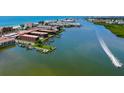 Gorgeous aerial view of condos on the water with a view of the ocean and a jetski at 19701 Gulf Blvd # 328, Indian Shores, FL 33785
