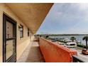 Exterior condo corridor with access to units and scenic water view with boat docks at 19701 Gulf Blvd # 328, Indian Shores, FL 33785