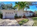 Exterior view of a well-kept single-story home with an attached garage and mature landscaping at 3621 S Belcher Dr, Tampa, FL 33629