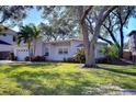 Attractive one-story home with white brick, a well-manicured lawn, and mature landscaping at 3621 S Belcher Dr, Tampa, FL 33629