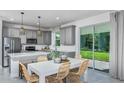 Modern kitchen with stainless steel appliances, an island, and a sliding door to the outdoors at 36424 Sespe Creek Ct, Zephyrhills, FL 33540