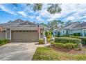 Well-kept house with a two-car garage and manicured landscaping for excellent curb appeal at 5718 Heronpark Pl, Lithia, FL 33547