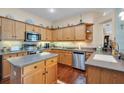 Spacious kitchen with stainless steel appliances, an island, and ample wood cabinetry at 5718 Heronpark Pl, Lithia, FL 33547