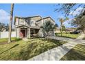 A lovely two story home featuring a lawn, landscaping, and a covered entry way with seating at 5914 Falconwood Pl, Lithia, FL 33547