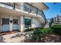 Exterior of condo building featuring stairs, landscaping, and brick walkway at 6211 Sun Blvd # 115, St Petersburg, FL 33715