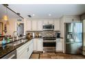 Well-lit kitchen boasts stainless steel appliances and dark granite countertops at 6211 Sun Blvd # 115, St Petersburg, FL 33715