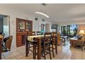 Bright dining area with seating for four and living room with a recliner and outdoor patio at 6268 Palma Del Mar S Blvd # 101, St Petersburg, FL 33715