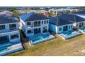 Aerial view of modern homes, each with a private pool, overlooking a picturesque neighborhood at 6536 Simone Shores Cir, Apollo Beach, FL 33572