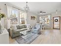 Inviting living room featuring hardwood floors, comfortable seating, and large windows with natural light at 1211 E Giddens Ave, Tampa, FL 33603