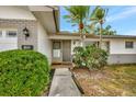 Inviting front entrance with a well-lit porch and attractive landscaping at 14005 Leeward Dr, Seminole, FL 33776