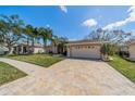 A spacious brick paver driveway leads to a well-maintained home with a two-car garage at 1509 Ventana Dr, Sun City Center, FL 33573