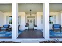 Inviting front porch with seating and blue rugs at 18531 Lithia Ranch Rd, Lithia, FL 33547