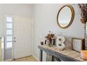 Bright entryway featuring a decorative table, stylish mirror, and a welcoming atmosphere with natural light at 2799 Wesleyan Dr, Palm Harbor, FL 34684