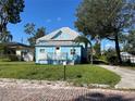 Charming light blue bungalow with a metal roof and a quaint front porch at 3110 N Massachusetts Ave, Tampa, FL 33603