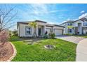 Charming single-story home featuring a spacious three-car garage and a well-manicured lawn at 3192 King Fern Dr, Wimauma, FL 33598