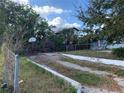 Picture of concrete driveway with basketball hoop overgrown with vegetation at 3208 N 15Th St, Tampa, FL 33605