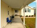 Relaxing covered porch featuring comfortable seating and a welcoming entrance at 37027 Lakota Ct, Zephyrhills, FL 33542