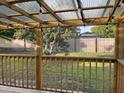 Cozy covered back porch with wood railings and a view of the spacious backyard at 6483 43Rd N Ave, Kenneth City, FL 33709