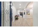 Inviting foyer with tiled floors, arched doorways, and a view into the living and dining areas at 706 Acacia Ct, Bradenton, FL 34212