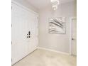 Bright entryway with white double doors and large artwork at 7309 Night Heron Dr, Land O Lakes, FL 34637