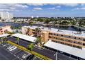 Aerial view of condos along a canal, showing parking, docks, and surrounding neighborhood at 7465 Bay Island S Dr # 115, South Pasadena, FL 33707