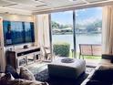 Bright living room features a large waterfront view and comfortable furniture for relaxing at 7465 Bay Island S Dr # 115, South Pasadena, FL 33707