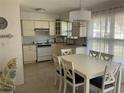 Bright eat-in kitchen with white cabinetry and a pendant light fixture over the dining table at 7998 115Th St, Seminole, FL 33772