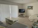 Cozy living room featuring neutral tones, a comfortable sofa, and natural light at 7998 115Th St, Seminole, FL 33772