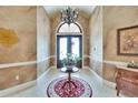 Elegant foyer with tile flooring, chandelier, and a view of the decorative double-door entry at 8510 Kentucky Derby Dr, Odessa, FL 33556