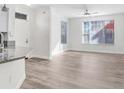 Living room with lots of natural light, neutral paint, and wood-look floors at 9142 Lake Chase Island Way # 9142, Tampa, FL 33626