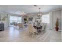 Spacious living room with elegant decor, a dining area, and large windows offering natural light at 11297 Pinot Dr, Venice, FL 34293