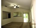 Open living room featuring neutral walls, carpet flooring, and a ceiling fan at 11818 Mango Groves Blvd, Seffner, FL 33584