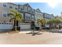 Inviting townhome exteriors with neat landscaping, palm trees, and private two-car garages at 1440 Harbour Walk Rd, Tampa, FL 33602