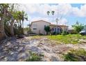 Charming home with a red tile roof, lush landscaping, and ample yard space at 15732 1St E St, Redington Beach, FL 33708