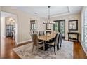 Elegant dining room featuring a tray ceiling, modern chandelier, and sliding glass doors at 17630 Brown Rd, Odessa, FL 33556