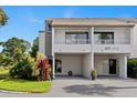 Clean two-story condo featuring a balcony, covered parking, and tidy landscaping at 2075 Lakewood Club S Dr # 6A, St Petersburg, FL 33712