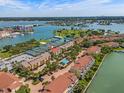 Stunning aerial view of a waterfront community with tennis courts, swimming pool, and beautiful bay views at 440 Sandy Hook Rd, Treasure Island, FL 33706