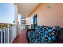 Cozy balcony featuring outdoor seating and white railings with a view of the community at 4516 Seagull Dr # 405, New Port Richey, FL 34652