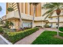 Well-maintained building entrance with lush landscaping and a brick walkway leading to the front door at 4525 Cove Cir # 805, St Petersburg, FL 33708