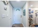 Inviting hallway featuring a closet, a white front door, and coastal-themed decorations at 4525 Cove Cir # 805, St Petersburg, FL 33708