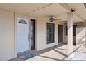 Covered front porch with white door, outdoor ceiling fans and decorative concrete flooring at 4801 Umber Ct, Tampa, FL 33624