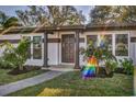 Inviting front entrance showcases updated landscaping and a well-maintained walkway at 525 Lamara Ne Way, St Petersburg, FL 33704