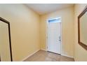 Bright foyer with tile flooring and a white front door at 6929 Breezy Palm Dr, Riverview, FL 33578